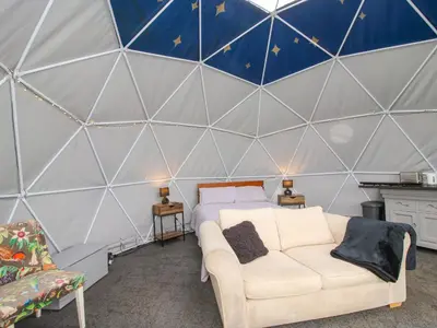 a room with a bed and a couch in a tent at Meadow View - Bryn-Mawr Retreat in Llanymynech