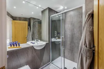 a bathroom with a glass shower and a sink at 4 Bed in Llansanffraid oc-p30384 in Llanymynech