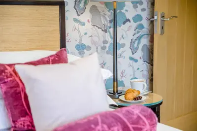 a bed with a plate of croissants and a cup of coffee at 4 Bed in Llansanffraid oc-k30383 in Llanymynech