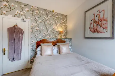 a bedroom with a bed with a flower patterned wall at 14 Bed in Llansanffraid oc-b30382 in Llanymynech