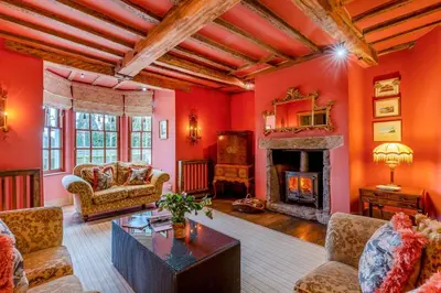 a living room with red walls and a fireplace at 14 Bed in Llansanffraid oc-b30382 in Llanymynech