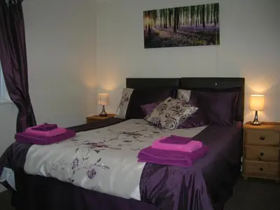 a bedroom with a bed with purple towels on it at Bevan House with Hot Tub in Mid-Wales in Hundred House