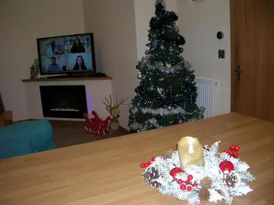 a christmas tree in a living room with a table at River Lodge Hot Tub Sleeps 6 in Hundred House