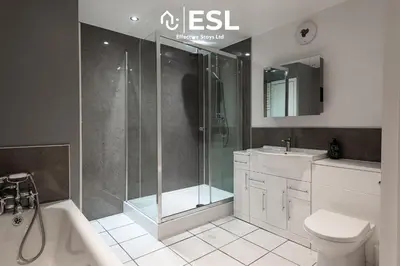 a bathroom with a shower and a toilet and a sink at 2 Bed Townhouse with Garden & Parking in Shrewsbury