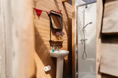 a bathroom with a sink and a mirror at Cefn Crib Safari Tent in Machynlleth