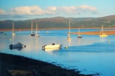 a group of boats in a large body of water at Westhaven 5 Beachfront Luxury-Free parking permit in Aberdyfi