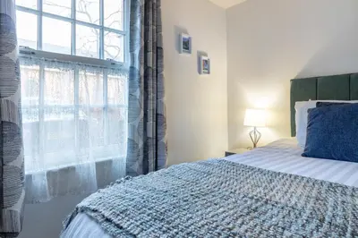 a bedroom with a bed and a large window at 2 bedroom apartment - Shrewsbury town centre in Shrewsbury