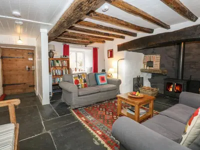 a living room with two couches and a fireplace at Tafarn Trip in Blaenau-Ffestiniog