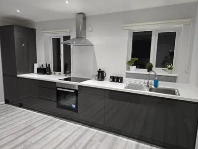 a kitchen with black and white counters and windows at Shrewsbury Creations in Shrewsbury