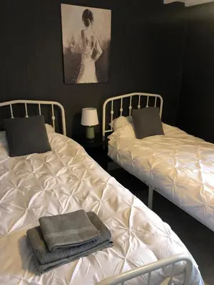 two beds sitting next to each other in a bedroom at The Eagles Inn in Rhayader