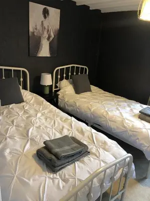 two beds sitting next to each other in a bedroom at The Eagles Inn in Rhayader