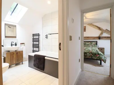 a bathroom with a tub and a sink at Sally's Barn in Oswestry