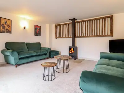 a living room with a couch and a fireplace at Sally's Barn in Oswestry