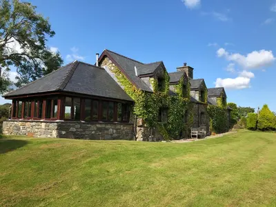 an old stone house with a large yard at Detached cottage in the hills near Dolgellau in Cross Foxes