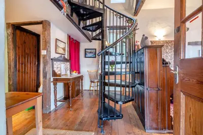 a black spiral staircase in a room with a table at 1 Bed in Llandderfel oc-t30475 in Llandderfel