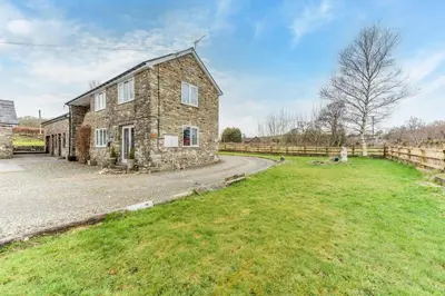 an old stone house in a field with a fence at 1 Bed in Drefach oc-m30848 in Llanwenog