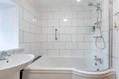 a white bathroom with a tub and a sink at 1 Bed in Drefach oc-m30848 in Llanwenog