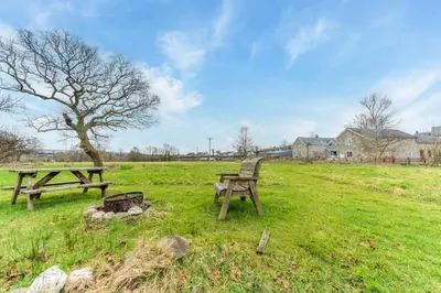 a picnic table and bench in a field at 1 Bed in Drefach oc-m30848 in Llanwenog
