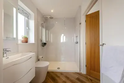 a bathroom with a shower and a toilet and a sink at 4 Bed in Aberarth oc-g30835 in Aberaeron