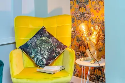 a yellow chair with a pillow on it next to a table at 4 Bed in Brecon oc-h30823 in Brecon