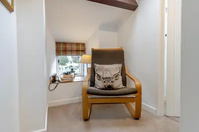 a chair with a pillow on it in a room at 2 Bed in Llanuwchllyn oc-t30615 in Llanuwchllyn