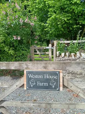 a sign for a museum house farm on a wooden fence at Herdsman's Hideaway in Leominster