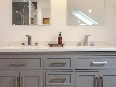 a bathroom with a sink and two mirrors at Gaerau Bach in Llanbedr