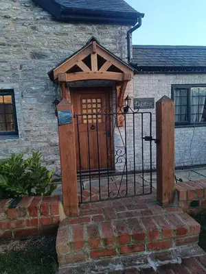 an entrance to a stone building with a wooden door at A peaceful cottage in the countryside in Abermule