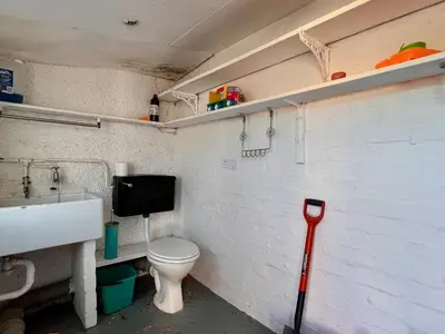 a small bathroom with a toilet and a sink at Glynmor in Harlech