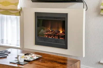 a living room with a fireplace on a wall at 2 Bed in Gilfachrheda oc-b30905 in Llanina
