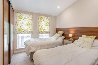 a bedroom with two beds and two windows at 2 Bed in Gilfachrheda oc-b30905 in Llanina