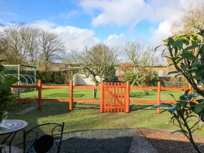 a wooden fence in a yard with a playground at Shed Your Blues in Hereford