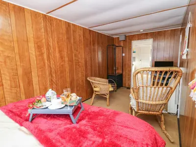 a living room with a table and chairs at Shed Your Blues in Hereford