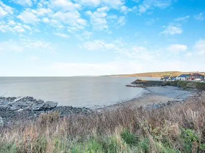 a view of a body of water with houses on the shore at Bettys Cottage in New Quay