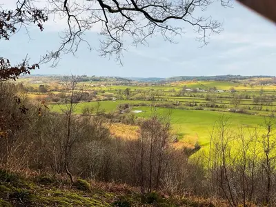 a view of a green field from a hill at Y Smithy - Uk49022 in Llanybydder