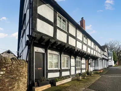 an old black and white building with windows at The Cottage in Weobley