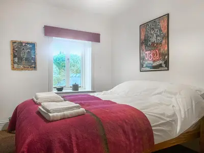 a bedroom with a bed with two towels on it at Cosy Cwtch in Hay-on-Wye