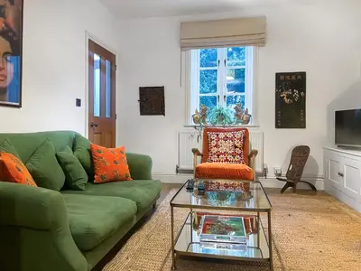 a living room with a green couch and a coffee table at Cosy Cwtch in Hay-on-Wye