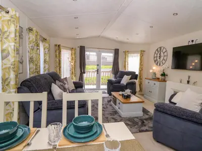 a living room with a couch and a table at 98 The Heron in New Quay