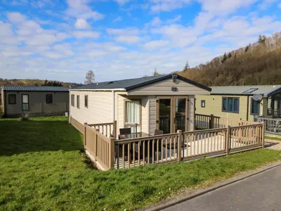 a mobile home with a porch and a deck at 98 The Heron in New Quay