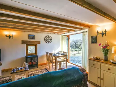 a living room with a couch and a table at Aberserw Cottage in Trawsfynydd