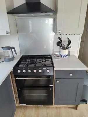 a kitchen with a stove top oven in a kitchen at Willerby Malton in Barmouth