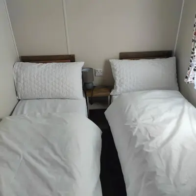 two beds sitting next to each other in a room at Willerby Malton in Barmouth