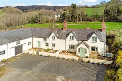 an aerial view of a large white house with a driveway at Tower Farm Holidays in Llangollen