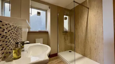 a bathroom with a sink and a shower at Below the castle at Snowdonia in Harlech