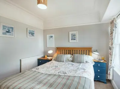 a bedroom with a bed with two night stands and two lamps at Below the castle at Snowdonia in Harlech
