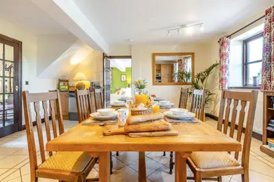a dining room with a wooden table and chairs at 2 Bed in Llangorse oc-t30290 in Llangorse