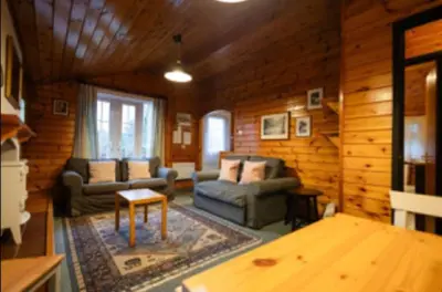 a living room with furniture in a log cabin at 345 Ida's Cabin in Trawsfynydd