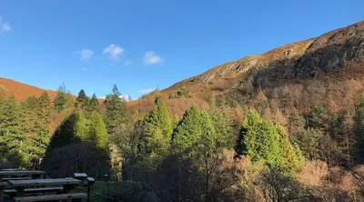 a picnic table in front of a mountain at Ty Penbont House in Rhayader