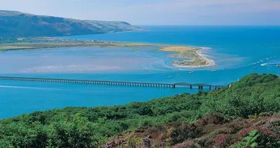 a bridge over a large body of water at Tan-y-Graig at Snowdonia in Harlech